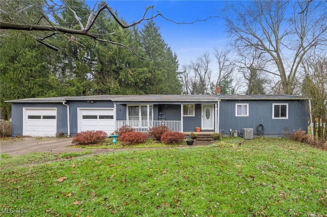 ranch-style home with covered porch, cooling unit, a garage, and a front lawn