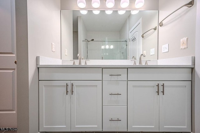 bathroom featuring vanity and a shower with shower door