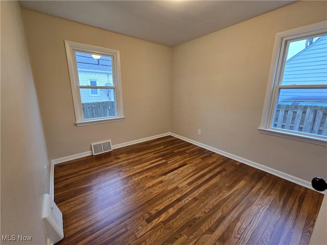 spare room with dark hardwood / wood-style flooring