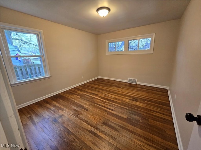 spare room with dark hardwood / wood-style floors