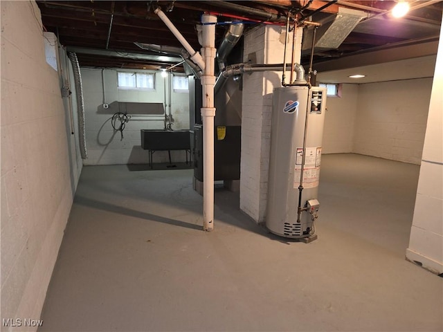 basement with gas water heater, sink, and heating unit