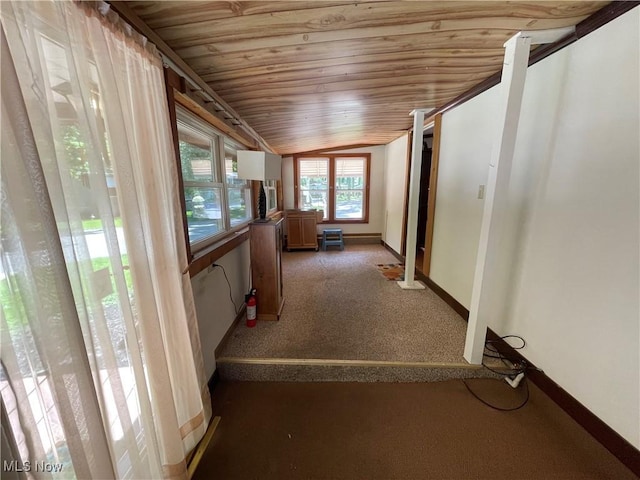 hallway featuring dark colored carpet, lofted ceiling, and wood ceiling