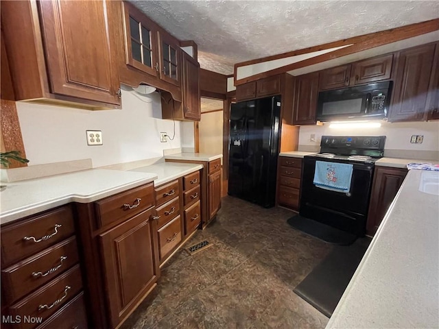 kitchen featuring a textured ceiling and black appliances