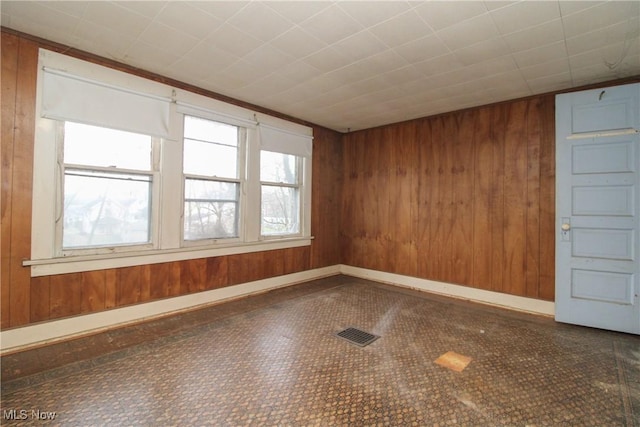 unfurnished room with wooden walls