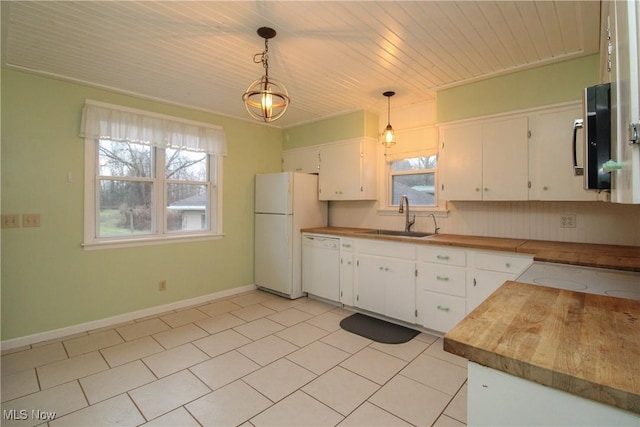 kitchen featuring sink, a healthy amount of sunlight, decorative light fixtures, white appliances, and white cabinets