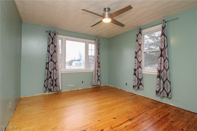 unfurnished room featuring hardwood / wood-style floors and ceiling fan