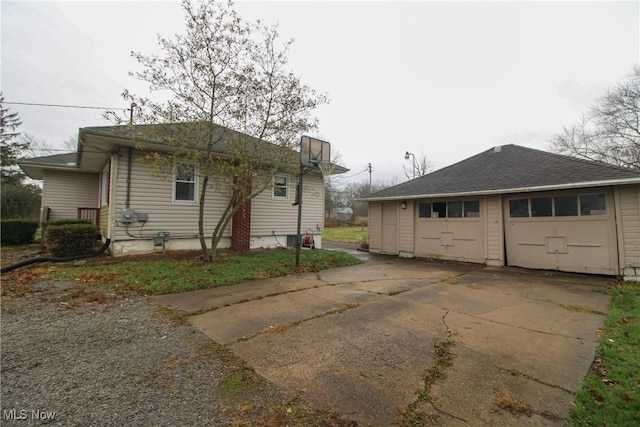 back of property with a garage and an outdoor structure