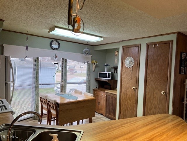 dining room with sink and a textured ceiling