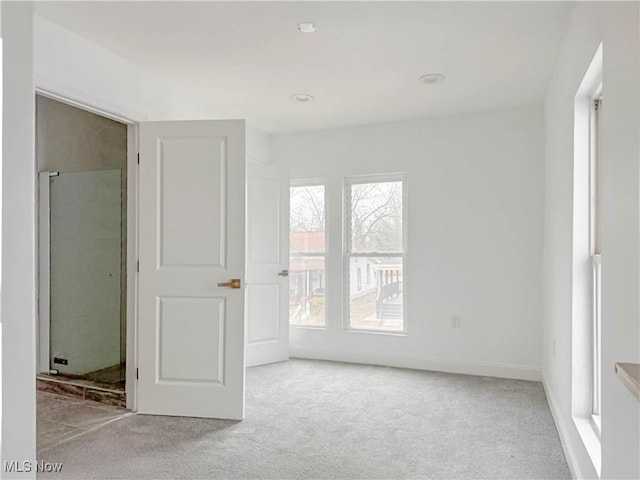 unfurnished bedroom featuring carpet flooring and baseboards