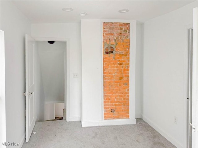 unfurnished bedroom featuring carpet floors and baseboards