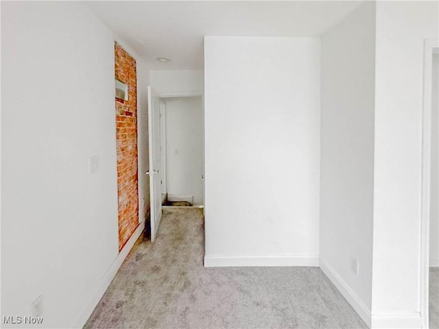 unfurnished room with carpet and baseboards