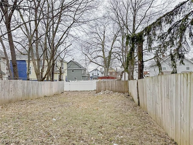 view of yard with a residential view and a fenced backyard