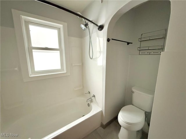 bathroom featuring shower / tub combination and toilet