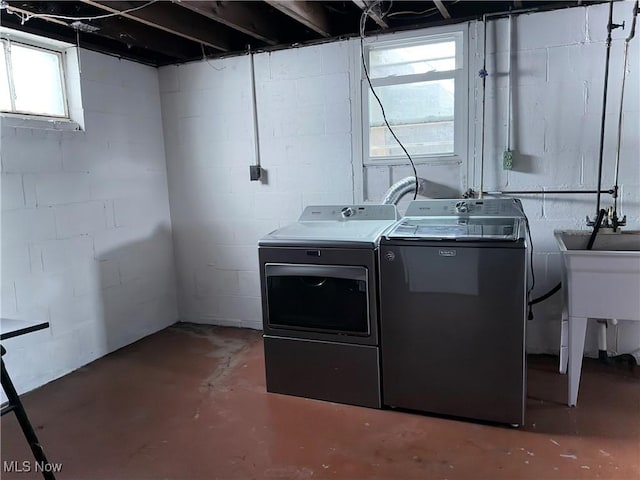 clothes washing area featuring washer and clothes dryer and a healthy amount of sunlight