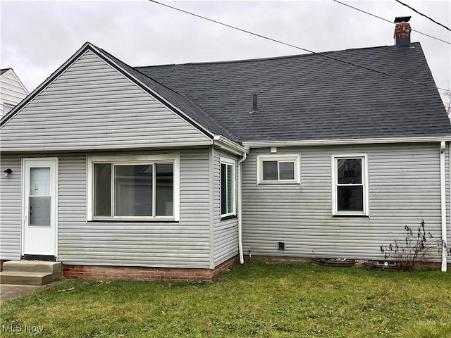 rear view of house with a lawn