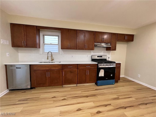 kitchen with dishwasher, gas range oven, light hardwood / wood-style floors, and sink