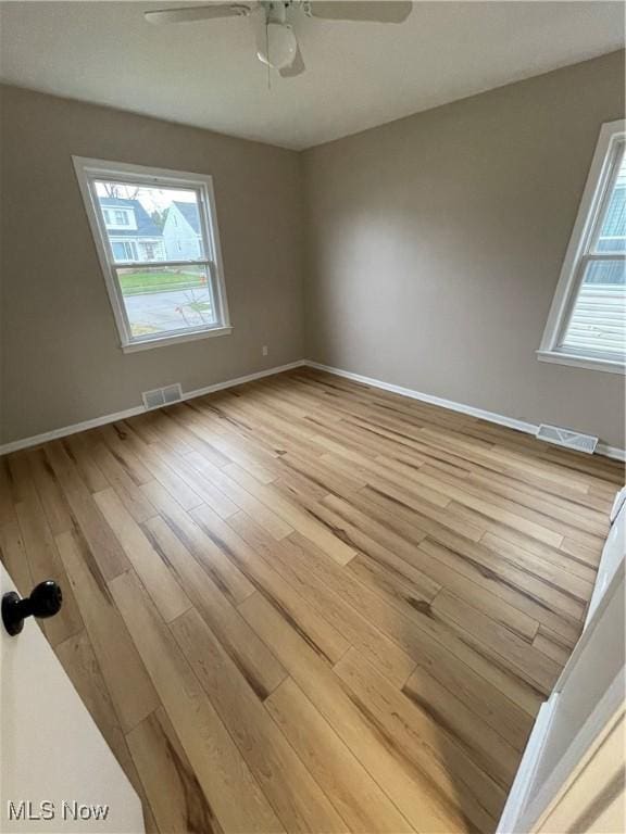 spare room with light hardwood / wood-style floors and ceiling fan