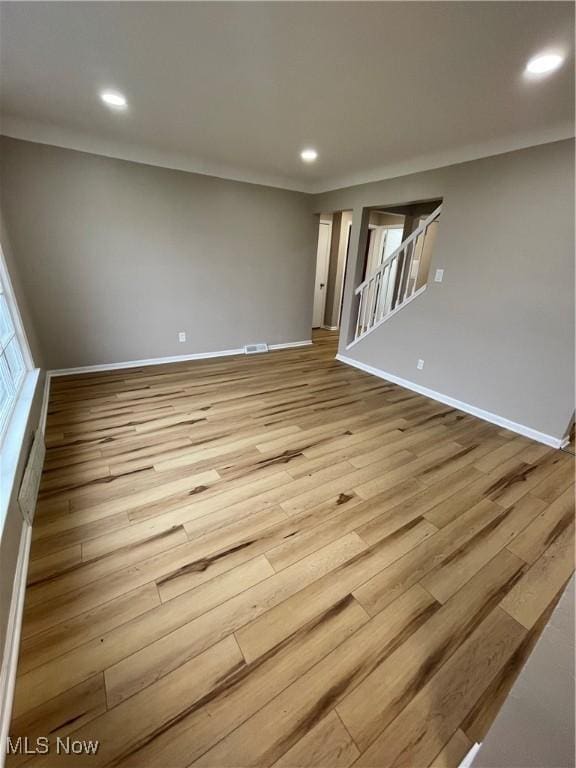 unfurnished room with light wood-type flooring