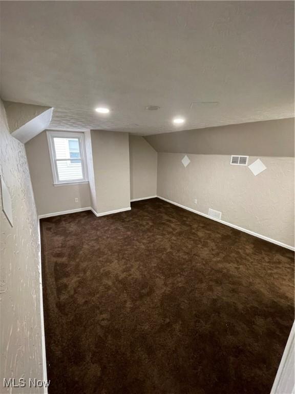 basement with dark colored carpet