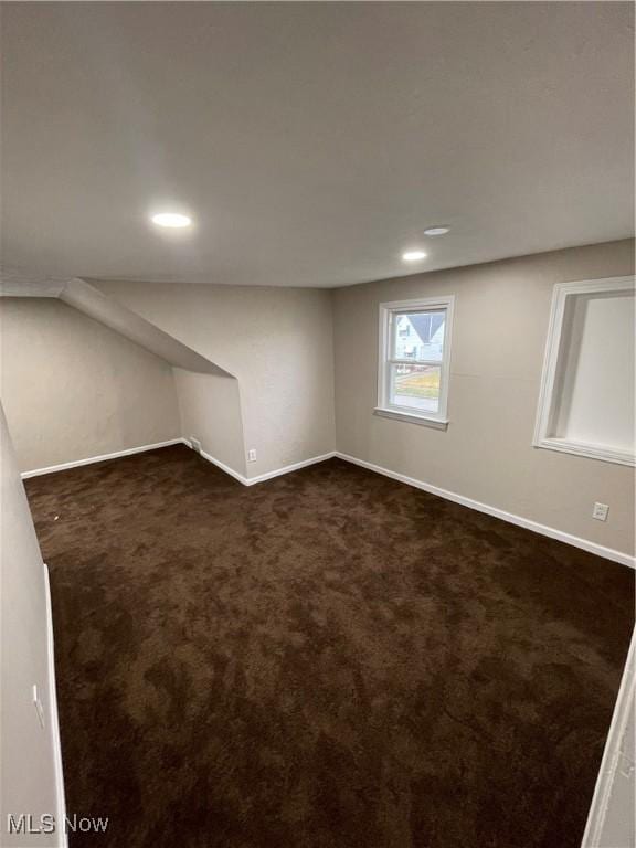 basement with dark colored carpet