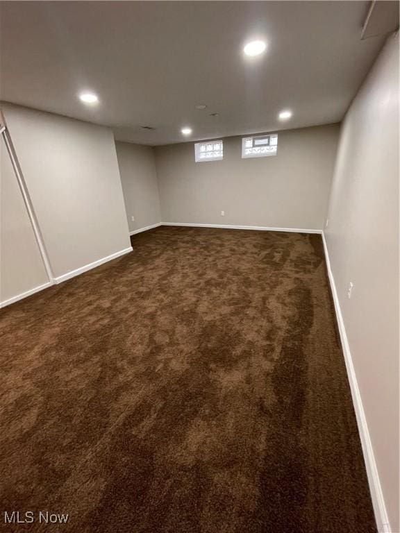 basement featuring dark carpet