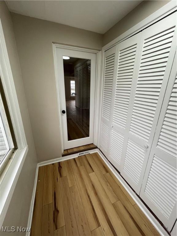 hallway with wood-type flooring