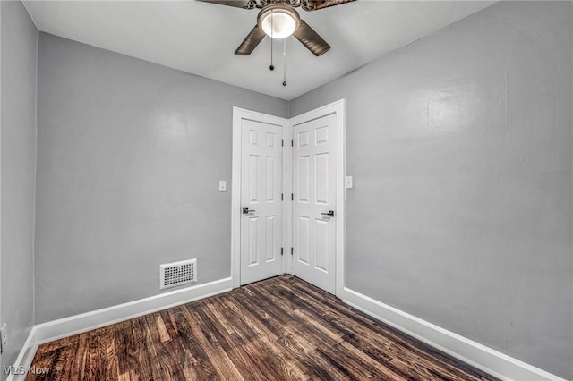 unfurnished room featuring ceiling fan and dark hardwood / wood-style flooring