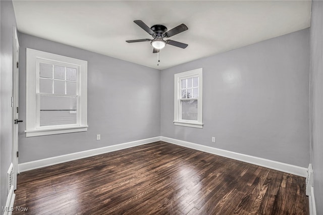 unfurnished room with ceiling fan and dark wood-type flooring