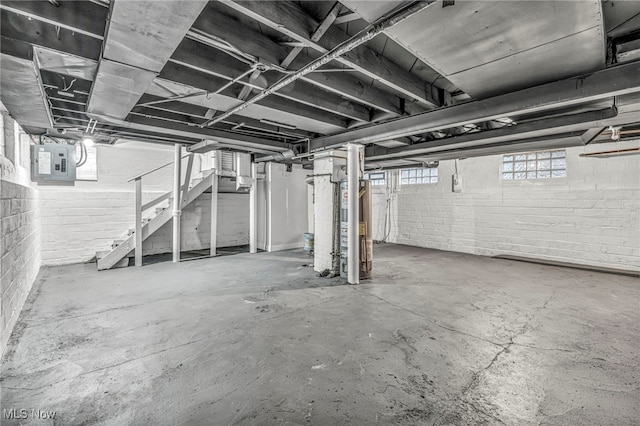 basement with electric panel and water heater