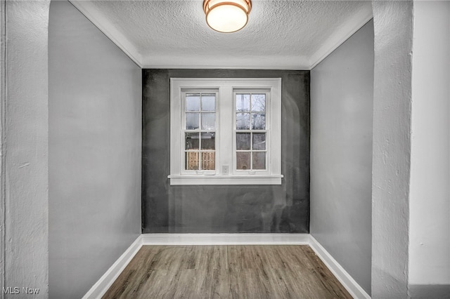 doorway to outside featuring wood-type flooring and a textured ceiling