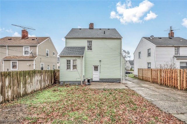 back of property featuring central air condition unit and a patio