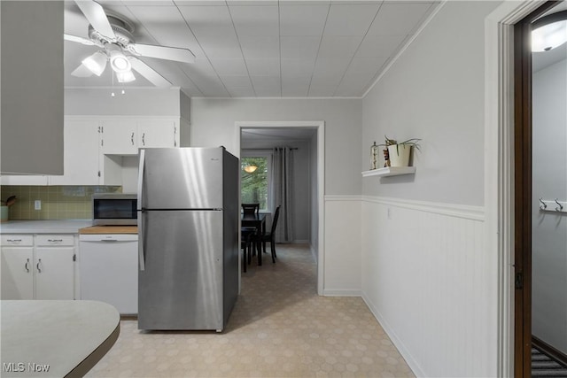 kitchen with white cabinetry, ceiling fan, tasteful backsplash, crown molding, and appliances with stainless steel finishes