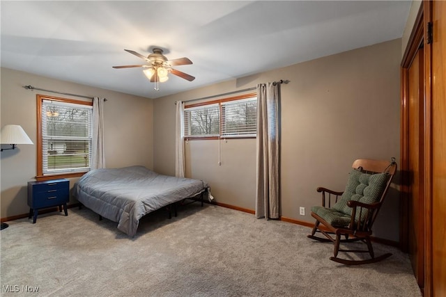 carpeted bedroom featuring ceiling fan and multiple windows