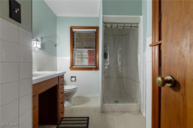 bathroom with vanity, curtained shower, toilet, and tile walls