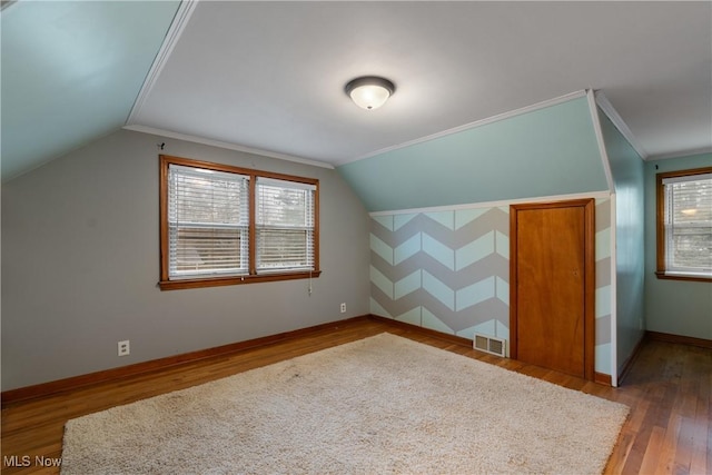 bonus room featuring hardwood / wood-style floors and vaulted ceiling