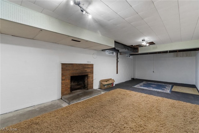 basement featuring a brick fireplace