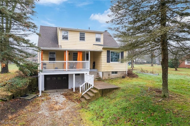 view of front of house with a garage and a front lawn