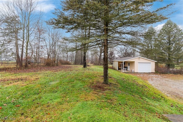 view of yard featuring an outbuilding and a garage