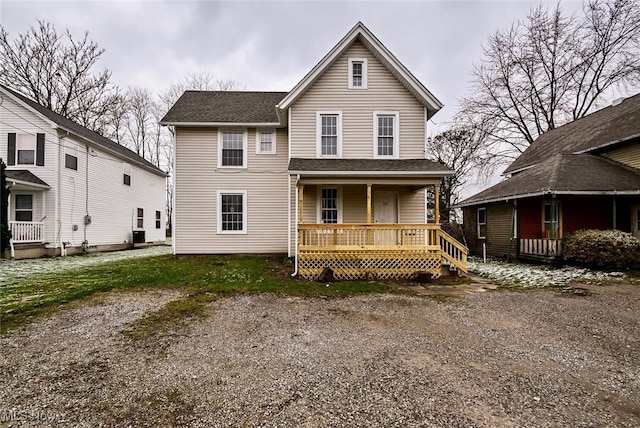 rear view of house with central AC and a porch