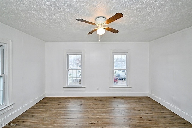 unfurnished room featuring a textured ceiling, ceiling fan, and dark hardwood / wood-style floors