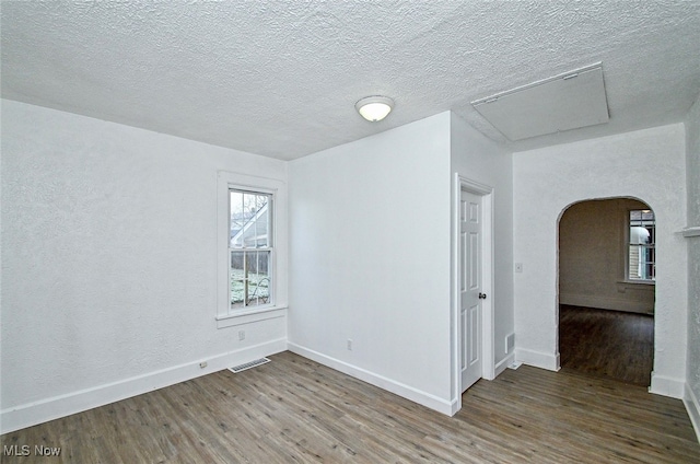 spare room with wood-type flooring and a textured ceiling