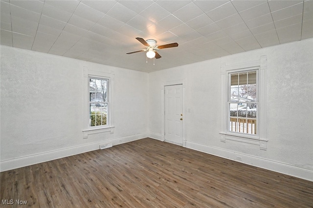 unfurnished room with dark hardwood / wood-style floors and ceiling fan