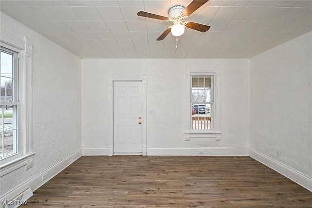 empty room featuring ceiling fan and dark wood-type flooring