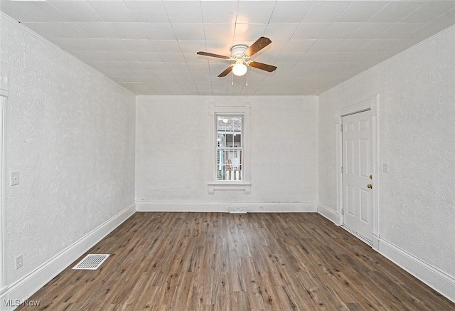 unfurnished room with dark hardwood / wood-style flooring and ceiling fan