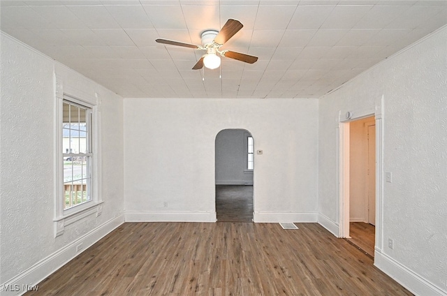 empty room with ceiling fan and dark hardwood / wood-style floors