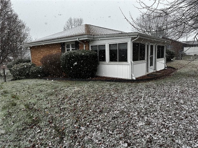 view of home's exterior with a sunroom