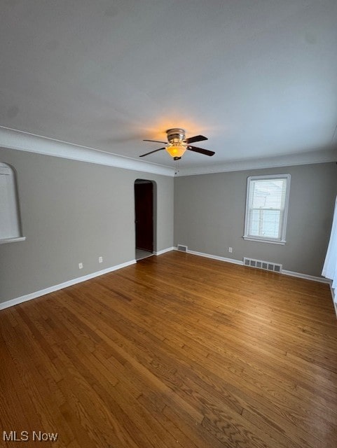 empty room featuring light hardwood / wood-style flooring, ceiling fan, and ornamental molding