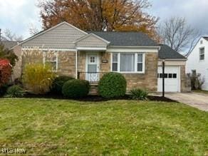 view of front facade featuring a front lawn and a garage