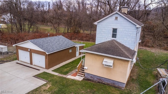 view of outdoor structure with a lawn and a garage