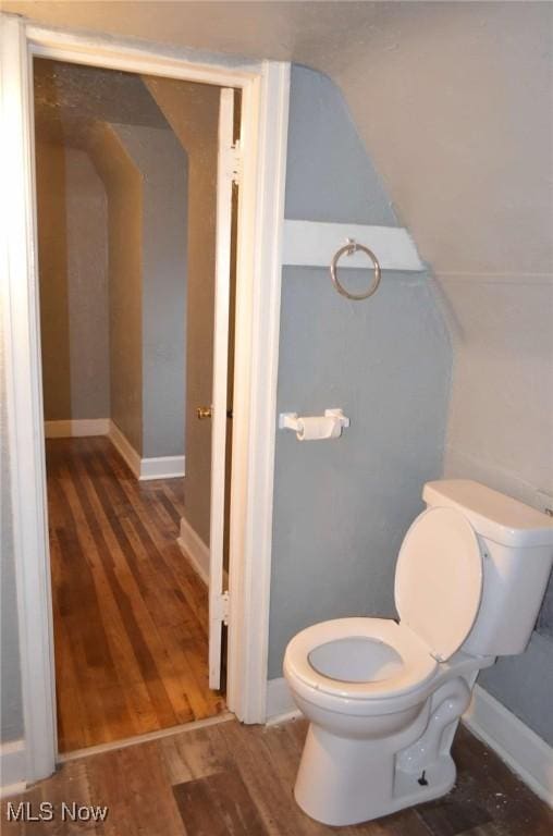 bathroom with toilet and wood-type flooring